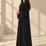 Front view of black Super Nida half-kloosh abaya 1073 with black appliqué.