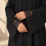Front view of black Super Nida half-kloosh abaya 1073 with black appliqué.